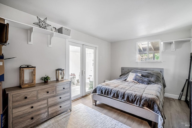 bedroom with access to outside, light wood-style flooring, baseboards, and french doors