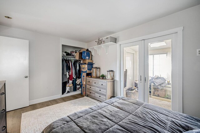 bedroom featuring a closet, baseboards, and wood finished floors