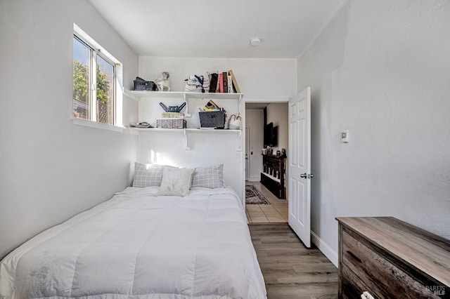 bedroom with wood finished floors
