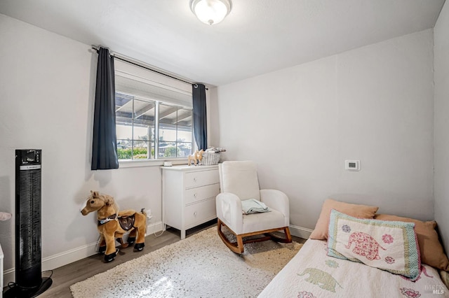 bedroom with baseboards and wood finished floors