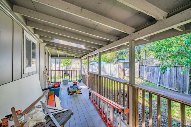 wooden deck with a fenced backyard