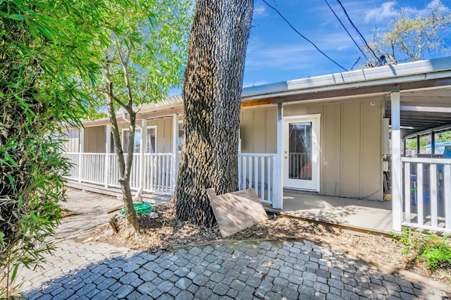 exterior space featuring board and batten siding and covered porch