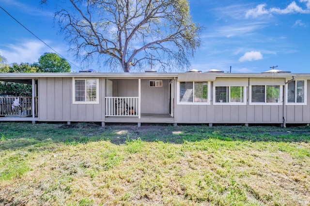 rear view of house with a yard