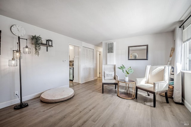 sitting room with light wood-style floors and baseboards