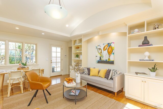 living room with built in features, baseboards, light wood-style flooring, recessed lighting, and vaulted ceiling