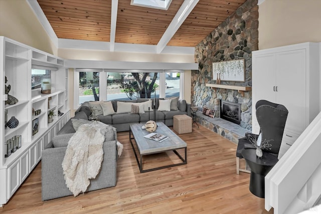 living room with beamed ceiling, wooden ceiling, a fireplace, light wood-style floors, and high vaulted ceiling