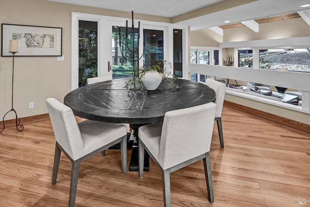 dining space featuring baseboards and light wood-style floors
