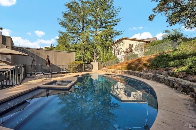 view of swimming pool with an in ground hot tub, fence, and a fenced in pool