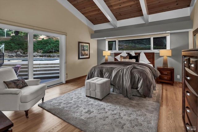 bedroom with access to exterior, vaulted ceiling with beams, and light wood finished floors