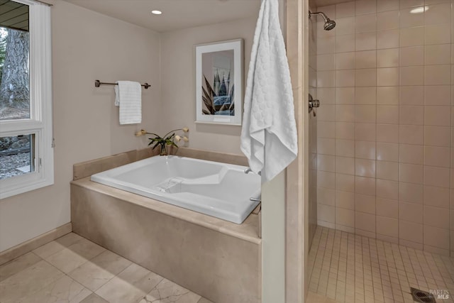 bathroom featuring tile patterned flooring, a stall shower, and a garden tub