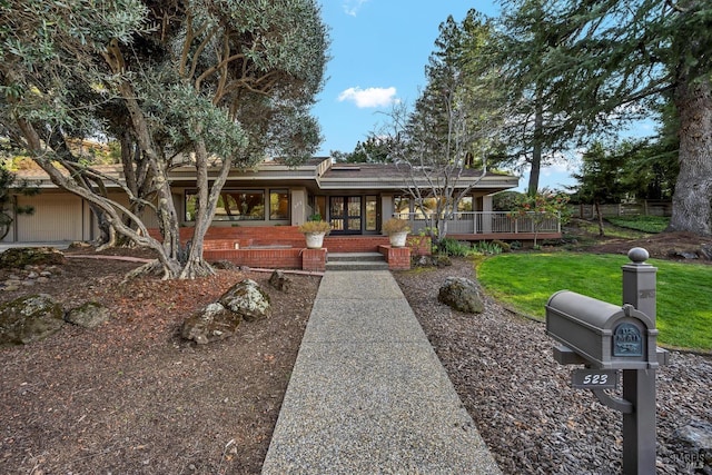 view of front facade with a front lawn and brick siding