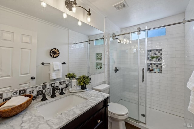 bathroom with visible vents, a shower stall, toilet, and plenty of natural light