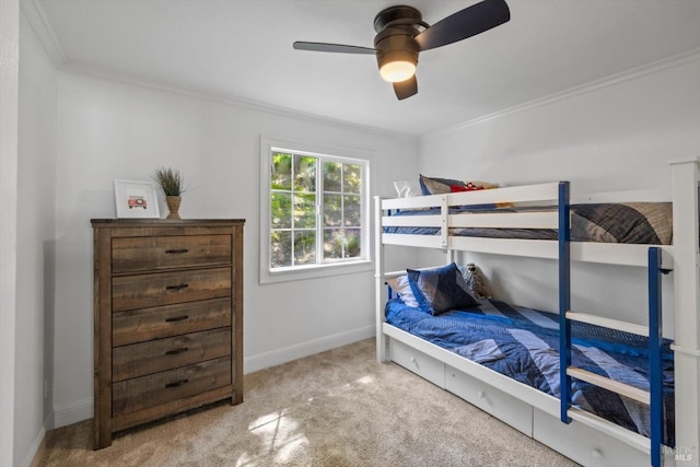 bedroom with ceiling fan, baseboards, ornamental molding, and carpet floors