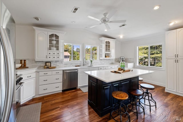248 Vine St, Vacaville, CA 95688 - kitchen with stainless steel appliances, a sink, plenty of natural light, a breakfast bar, and vaulted ceiling