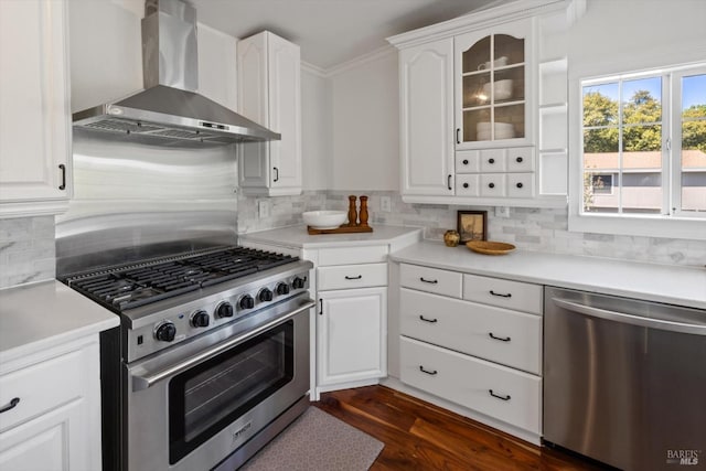 248 Vine St, Vacaville, CA 95688 - kitchen with appliances with stainless steel finishes, wall chimney exhaust hood, decorative backsplash, and white cabinetry