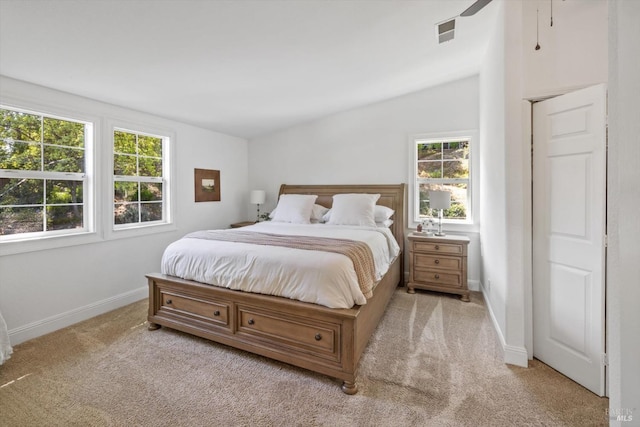 bedroom with visible vents, vaulted ceiling, carpet, and baseboards