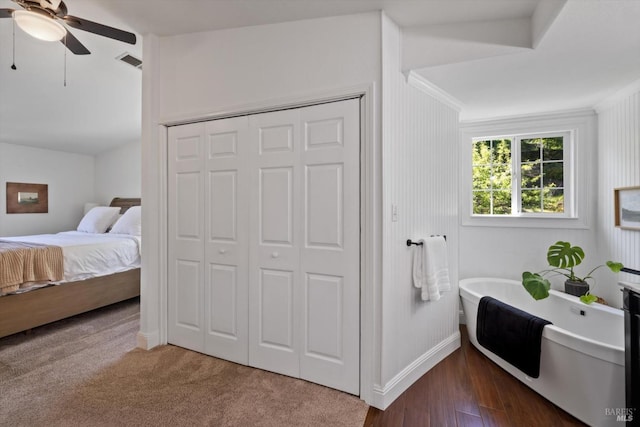 ensuite bathroom with visible vents, baseboards, a freestanding tub, a ceiling fan, and ensuite bath