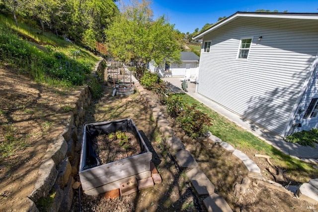 exterior space featuring fence and a vegetable garden