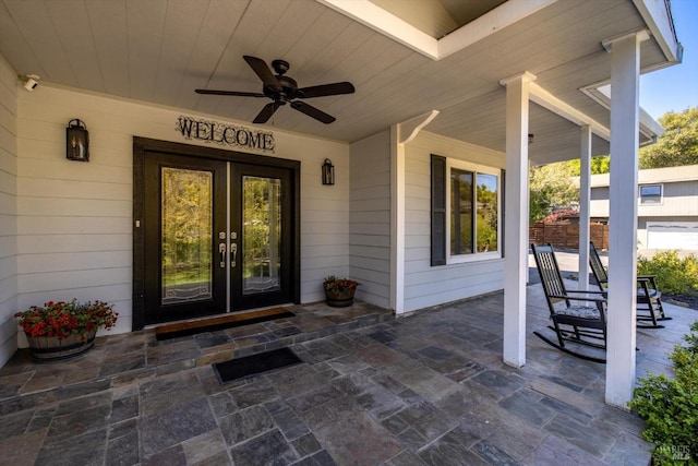 property entrance with a ceiling fan, covered porch, and french doors