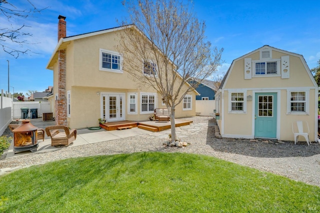752 Chula Vista Way, Suisun City, CA 94585 - rear view of property featuring a fire pit, a chimney, stucco siding, an outbuilding, and a fenced backyard