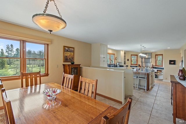dining area with baseboards and light tile patterned floors