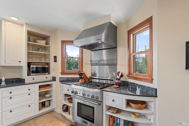 kitchen featuring open shelves, stainless steel appliances, and wall chimney exhaust hood