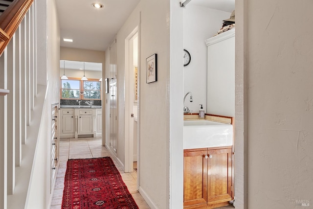 hall with light tile patterned floors