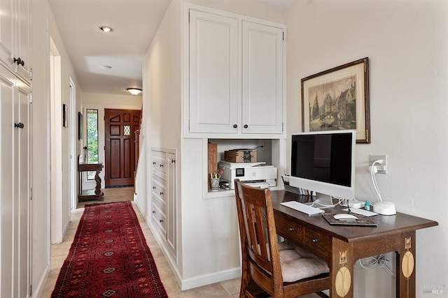 home office with light tile patterned floors and baseboards