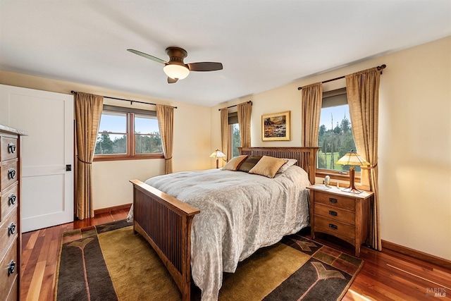 bedroom featuring baseboards, ceiling fan, and wood finished floors
