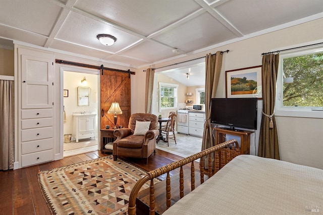bedroom with wood-type flooring, a barn door, coffered ceiling, and ensuite bathroom