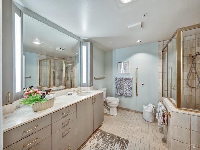 bathroom with toilet, tile patterned floors, a shower stall, and vanity