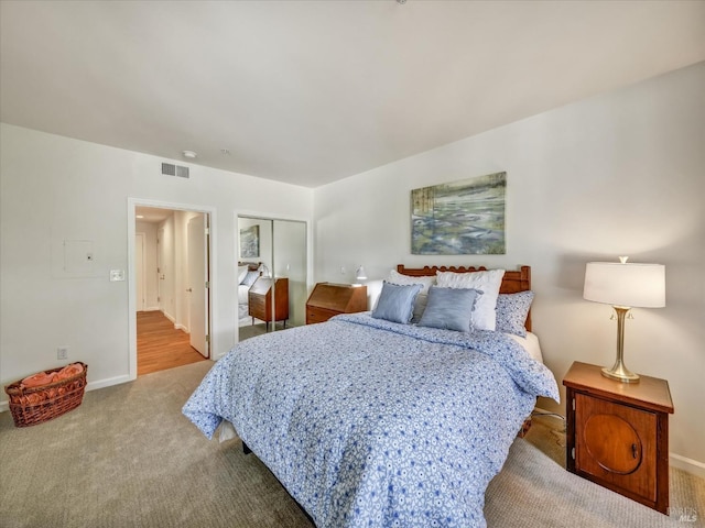 bedroom featuring visible vents, baseboards, a closet, and carpet