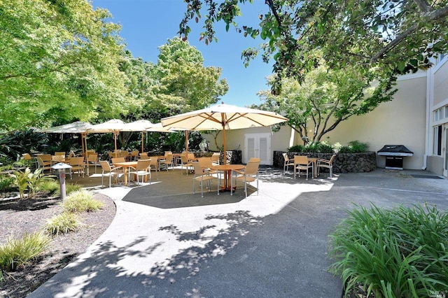view of patio with outdoor dining area and area for grilling