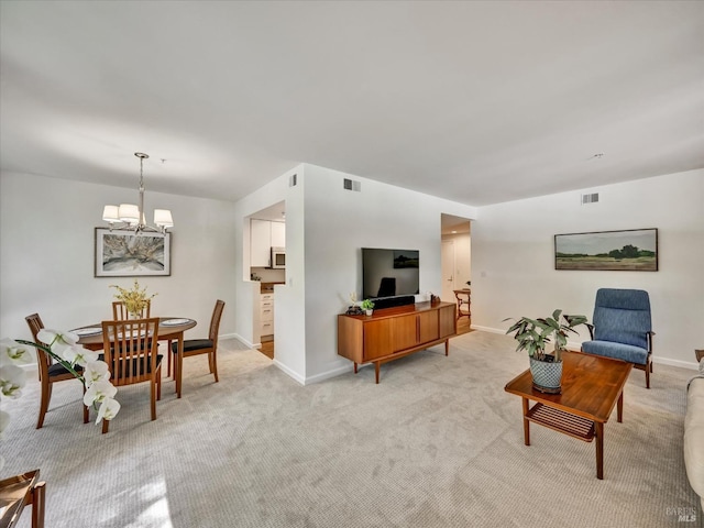 living room featuring a chandelier, visible vents, light colored carpet, and baseboards