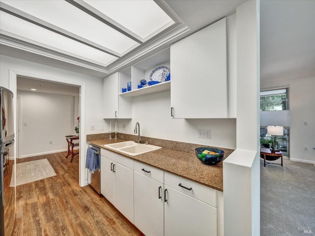 kitchen featuring a sink, white cabinets, open shelves, and dishwasher