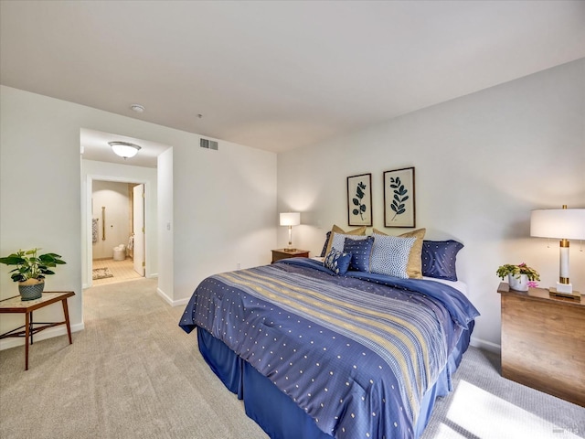 carpeted bedroom with visible vents and baseboards