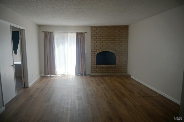 237 Sunflower Ct, Fairfield, CA 94533 - unfurnished living room featuring wood finished floors, a textured ceiling, a brick fireplace, and baseboards
