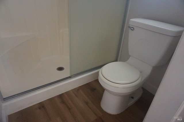 237 Sunflower Ct, Fairfield, CA 94533 - bathroom featuring wood finished floors, a stall shower, and toilet