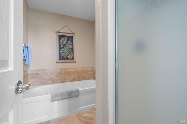 full bath featuring a bath, a stall shower, and tile patterned flooring