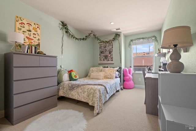 carpeted bedroom featuring baseboards and visible vents