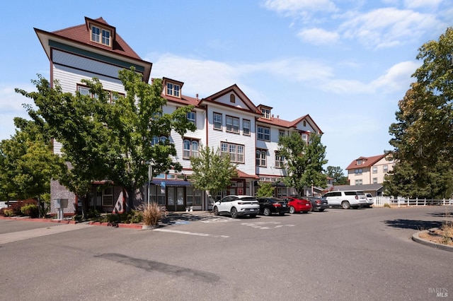 view of property featuring uncovered parking