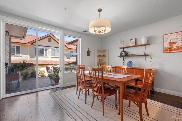 dining area featuring baseboards and wood finished floors
