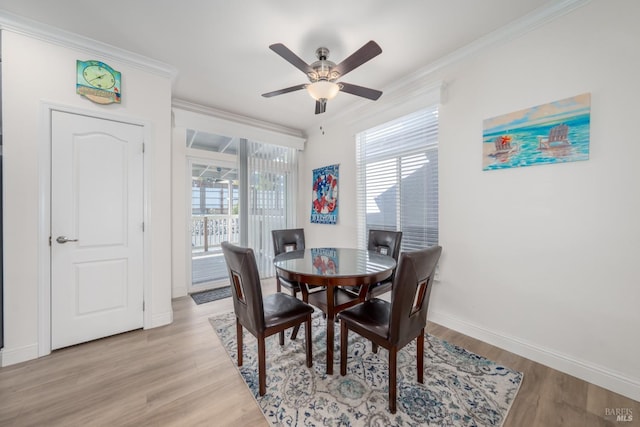 dining room with baseboards, light wood-style floors, a ceiling fan, and ornamental molding