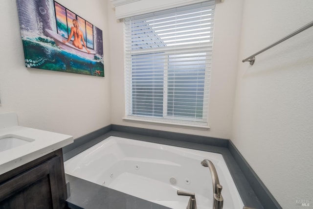 full bath featuring vanity and a jetted tub