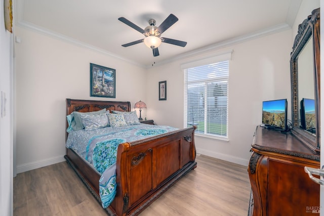 bedroom with baseboards, light wood finished floors, and ornamental molding