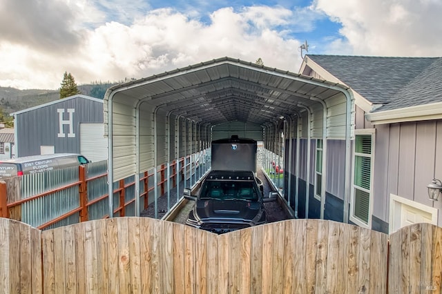 view of car parking with a carport and fence