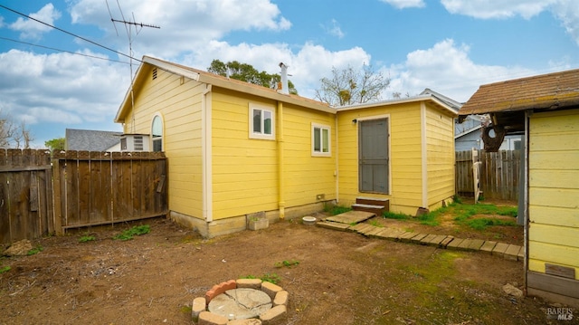 rear view of house featuring a fenced backyard and entry steps