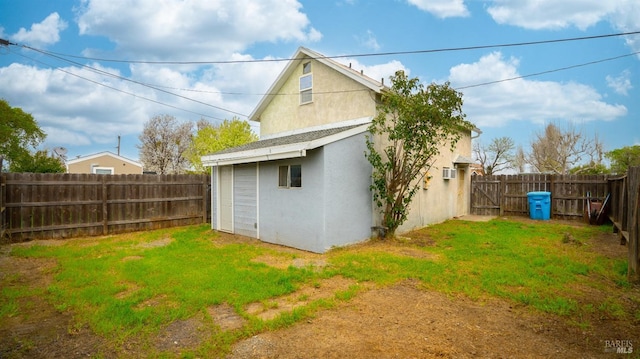 exterior space with a fenced backyard, stucco siding, and a yard
