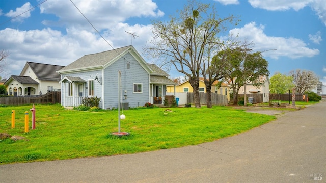 view of front of house featuring a front yard and fence