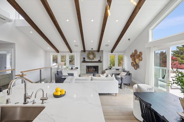 35 Bernard St, Mill Valley, CA 94941 - living room with light wood finished floors, plenty of natural light, beamed ceiling, a glass covered fireplace, and an AC wall unit